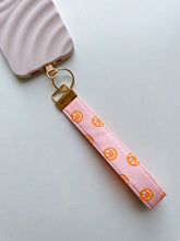Load image into Gallery viewer, Phone Wrist Strap - pink & orange smileys