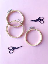 將圖片載入圖庫檢視器 Black and silver stork embroidery scissors, and bamboo embroidery hoops on pink background