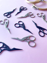 Load image into Gallery viewer, Black and silver stork embroidery scissors on pink background
